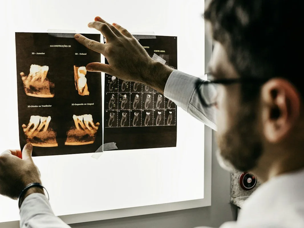 Technician reviewing scans on a lightbox